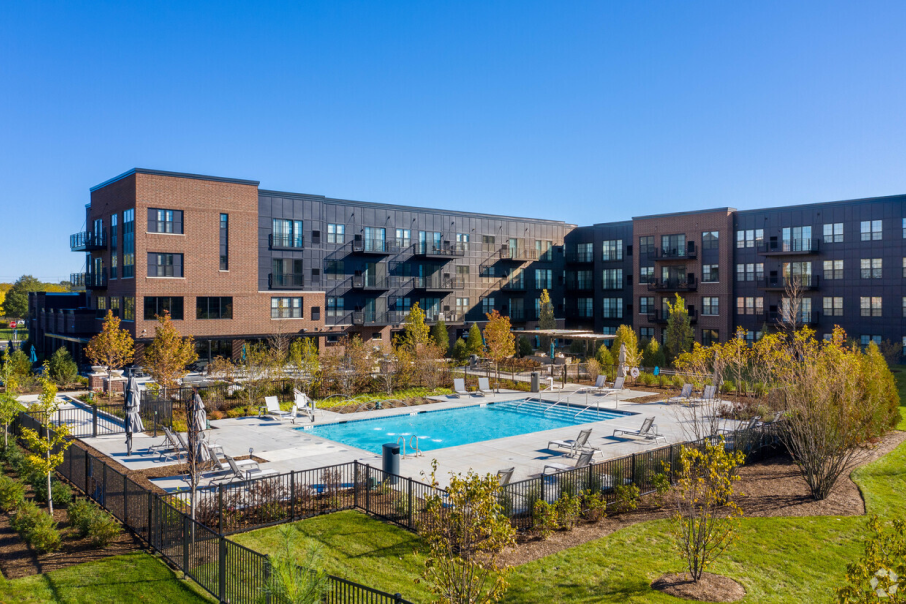 An aerial view of the Element at Veridian Condos at 90 North Schaumburg featuring contemporary architecture, a resort-style pool, and landscaped green spaces.