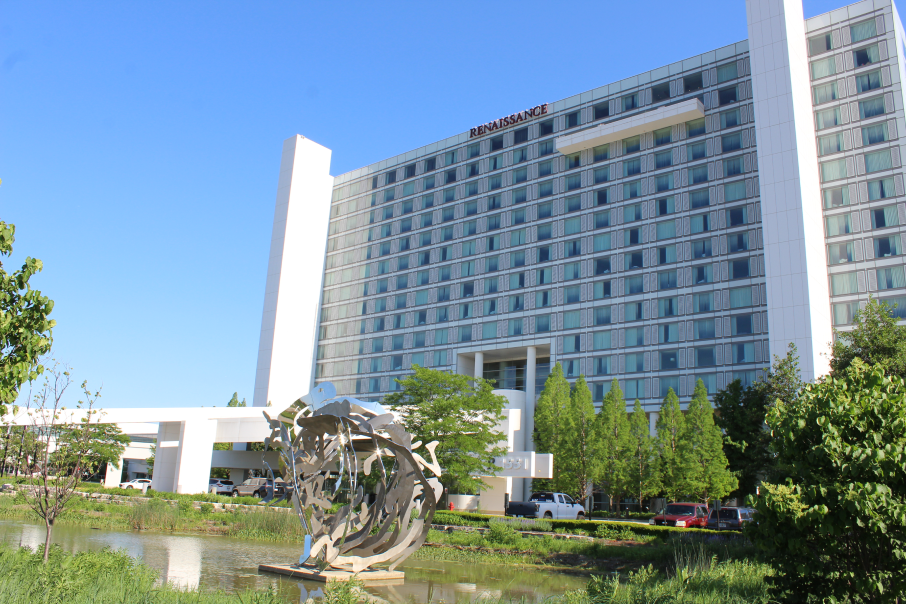 The Renaissance Hotel and Convention Center at 90 North Schaumburg, featuring modern architecture, lush landscaping, and serene water features.