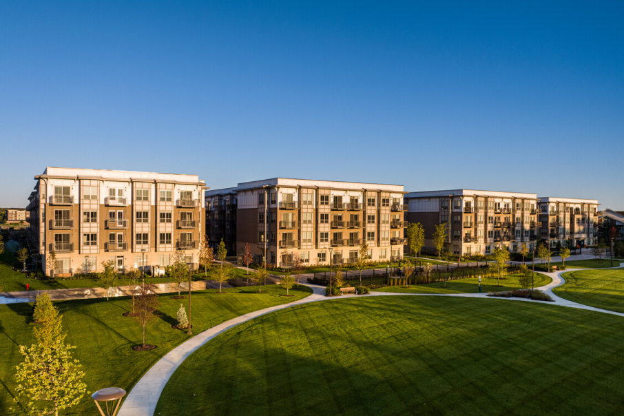 The Quin Condos at 90 North, offering a modern residential community with open lawns, walking paths, and scenic surroundings.